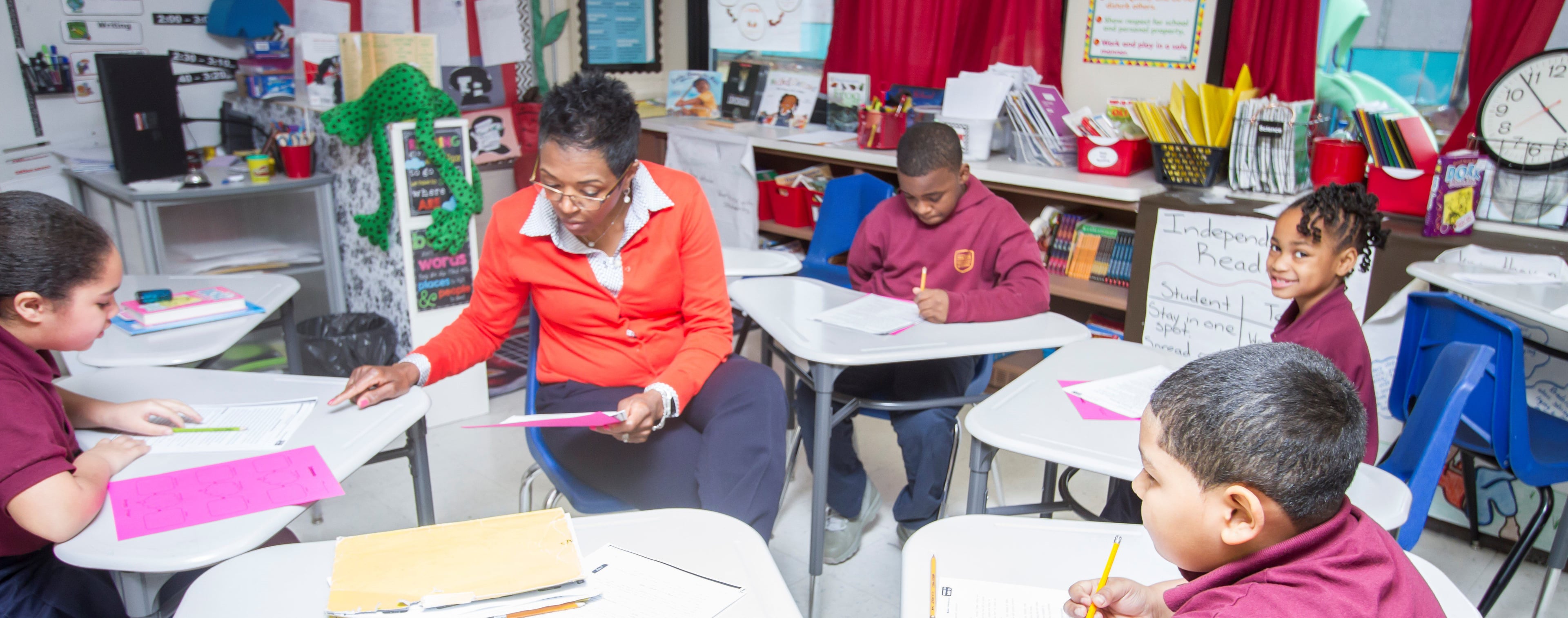 Adult and children in a classroom.